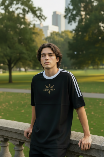 Man wearing a black and white sports outfit with 'Seraphim' branding, standing on a tree-lined street.
